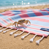 Crab on a Moonessa lightweight Turkish towel at the beach, showing how the loop-free weave stays virtually sand-free.