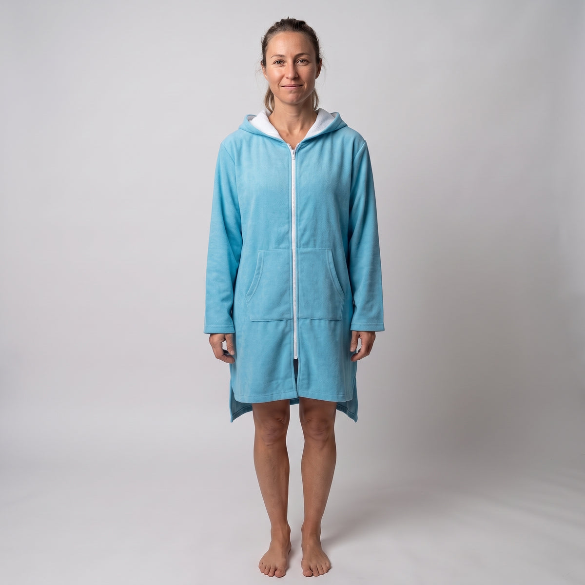 Woman wearing the long sleeve Santorini solid aqua adult hooded towel, studio front view