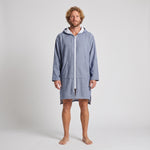 Man wearing the long sleeve Santorini solid navy adult hooded towel, studio front view