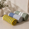 Three Moonessa Turkish towels representing Lightweight, Midweight and Plush weight classes, illustrating the performance differences between Turkish towel weights.
