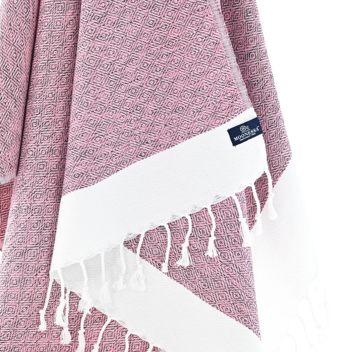 Close-up of the Madrid Turkish towel's mauve diamond weave with hand-twisted tassels
