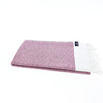Madrid Turkish towel in mauve folded flat, showing the combed cotton diamond weave
